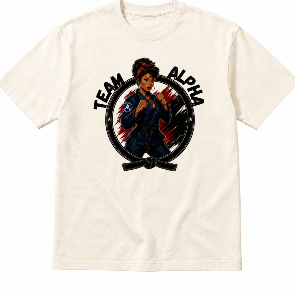 An off-white crewneck t-shirt featuring a graphic print of a martial arts fighter inside a circle with the text 'TEAM ALPHA' on a plain white background.