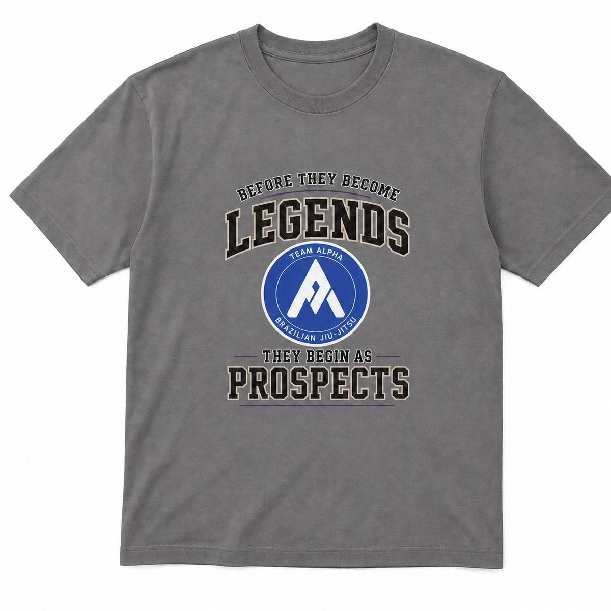 A gray short-sleeve crewneck t-shirt with a graphic print on the front. The graphic features the text 'BEFORE THEY BECOME LEGENDS THEY BEGIN AS PROSPECTS' in a distressed black font, surrounding a circular blue and white logo for 'Team Aloha Wailuku High School'.